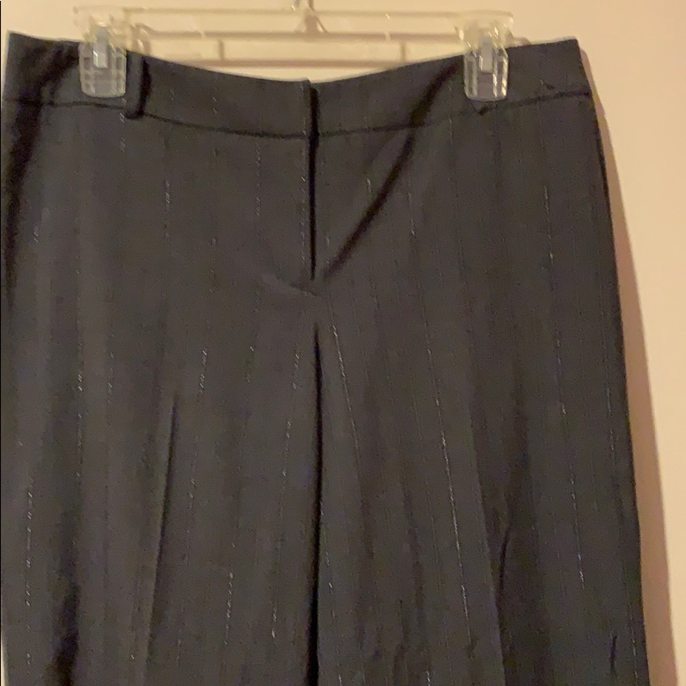 Dark grey trousers with silver pin stripe.